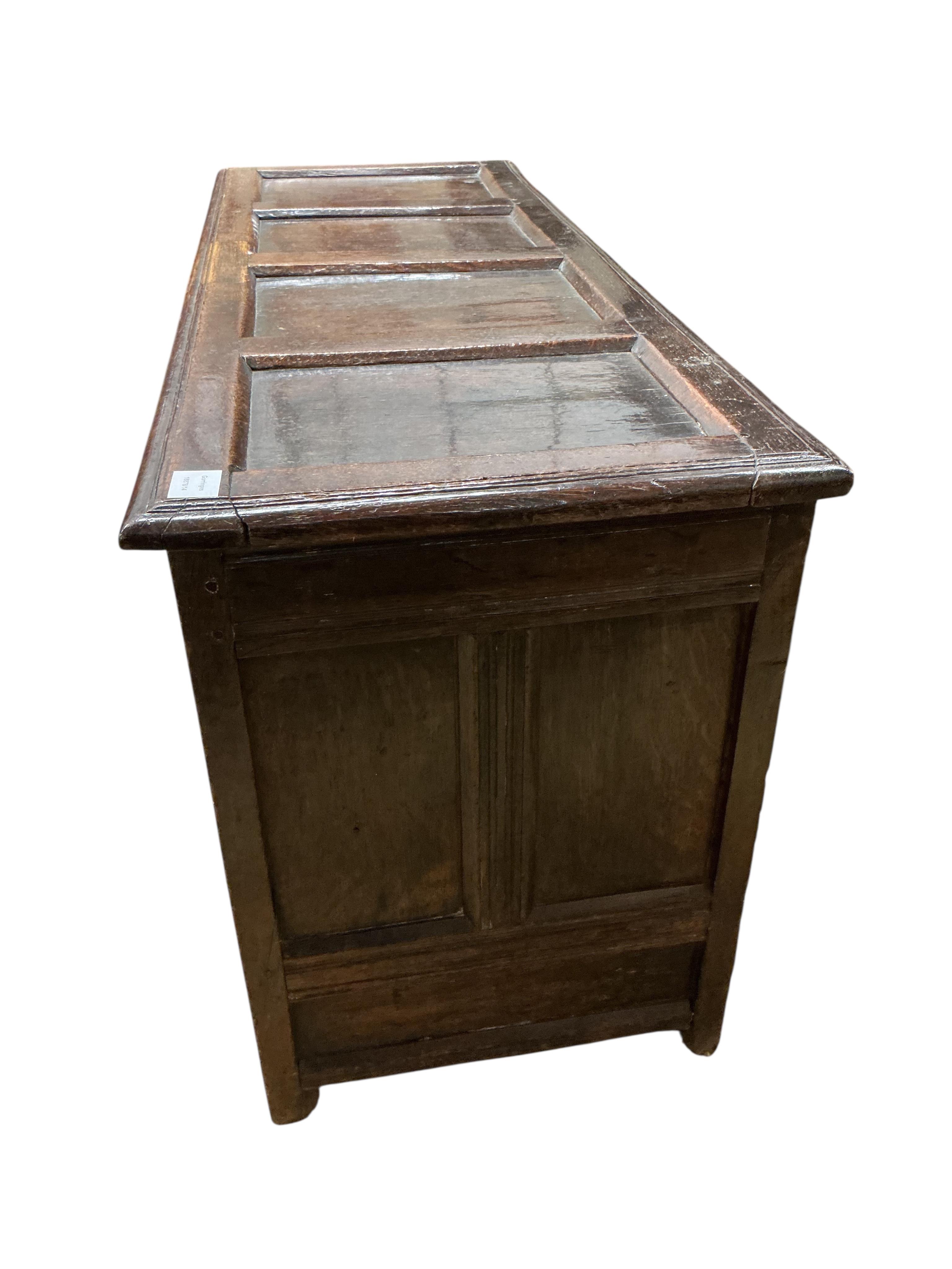 A late 17th century carved oak triple panelled coffer, the top rail monogrammed D.M, width 128cm, depth 48cm, height 68cm